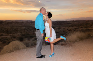 Photographers of Las Vegas - Wedding Photography - wedding couple at valley of fire sunset bride grabbing grooms tie