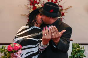 Photographers of Las Vegas - Wedding Photography - wedding bride and groom kissing while showing off rings
