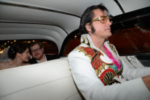 Photographers of Las Vegas - Wedding Photography - wedding bride and groom riding in Pink Cadillac with Elvis impersonator