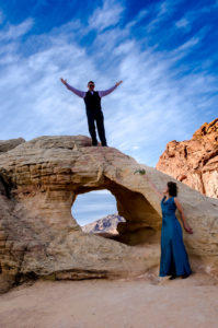 Photographers of Las Vegas - Wedding Photography - wedding couple climbing arch at valley of fire