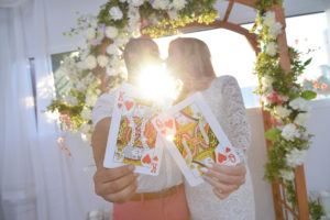 Photographers of Las Vegas - Wedding Photography - wedding couple sun flare as bride and groom kiss with King and queen of hearts