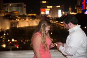Photographers of Las Vegas - Vegas Strip Tour Photography - Putting the ring on her finger after proposal