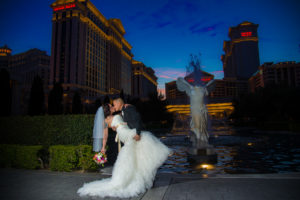 Photographers of Las Vegas - Wedding Photography - wedding couple groom dips and kisses the bride at sunset Ceasars Palace