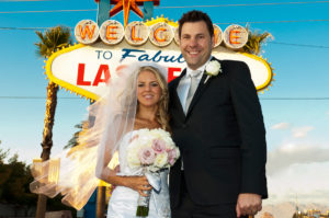 Photographers of Las Vegas - Wedding Photography - wedding bride and groom in front of sign background removed