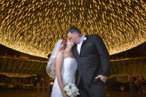 Photographers of Las Vegas - Vegas Strip Tour Photography - couple kiss in front of Plaza lights