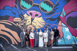 Photographers of Las Vegas - Wedding Photography - Group wedding photo in front of graffiti