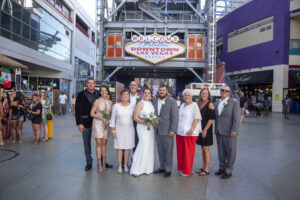 Photographers of Las Vegas - Wedding Photography - Group wedding photo in front downtown Vegas Sign
