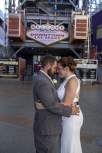 Photographers of Las Vegas - Wedding Photography - Bride and Groom romantic image at the Downtown Las Vegas Sign