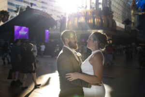 Photographers of Las Vegas - Wedding Photography - Bride and Groom romantic creative sun flare on Fremont Las Vegas