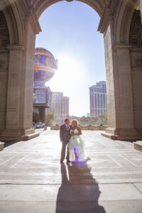 Photographers of Las Vegas - Wedding Photography - Sun Flare Wedding Photo in front of Vegas Casino