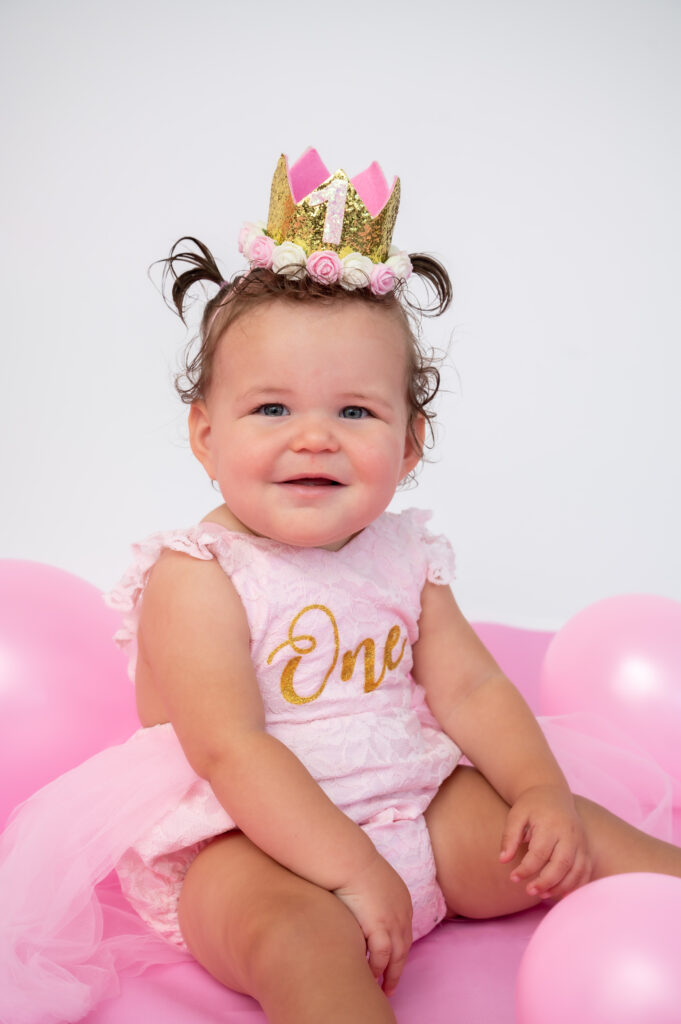 Photographers of Las Vegas – Studio Photography – Baby Birthday Portrait Pink Floor White Backdrop Balloons