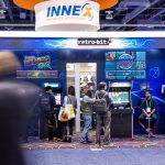 Photographers Of Las Vegas - Event Photography - Convention people walking blur retro-bit video game arcade machine playing Innex innovative accessories