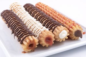 Photographers Of Las Vegas - Churros filling drizzle on top white plate