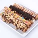 Photographers Of Las Vegas - Churros filled inside peanuts fruity pebbles Oreo drizzle toppings white plate