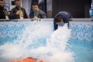 Photographers Of Las Vegas - Corporate Photography - Men watching presentation pool water convention demonstration