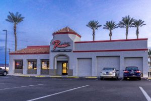 Photographers Of Las Vegas - Commercial Photography - Restaurant Rburgers red neon lights cars parking lot food daytime palm trees