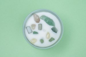 Photographers Of Las Vegas - Commercial Photography -White Candle crystal stones in wax mint green background