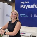 Photographers Of Las Vegas - Event Photography - Woman black blouse convention professional attire meeting blue plug into paysafe commercial red nails