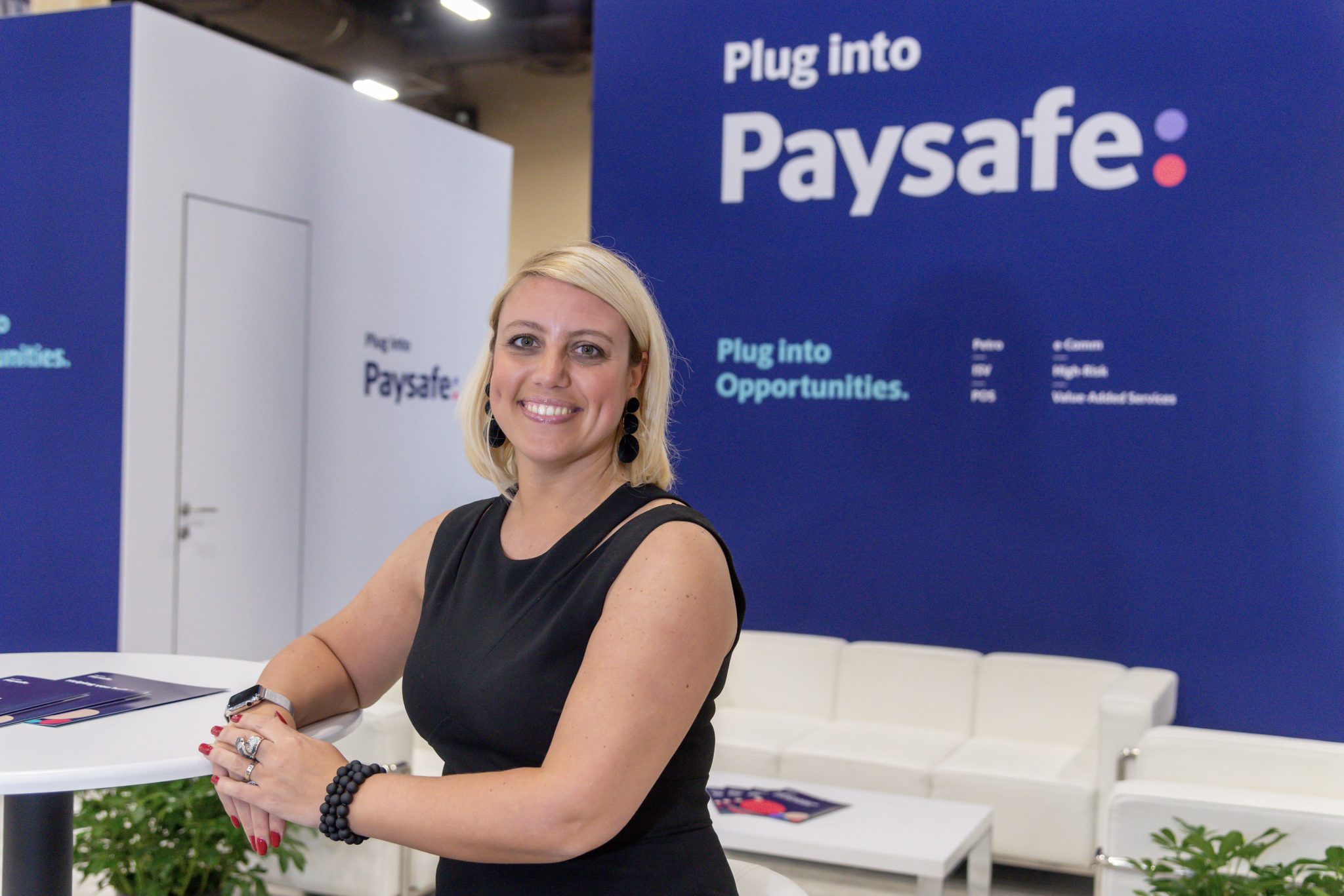 Photographers Of Las Vegas - Event Photography - Woman black blouse convention professional attire meeting blue plug into paysafe commercial red nails