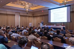 Photographers Of Las Vegas - Event Photography - Men with black blazers button up convention meeting slideshow large conference room