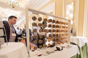 Photographers Of Las Vegas - Event Photography - Man with black blazer pattern button up convention donut wall