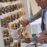 Photographers Of Las Vegas - Event Photography - Men with black blazer blue button up and blue polo. Man professional attire. Donut wall