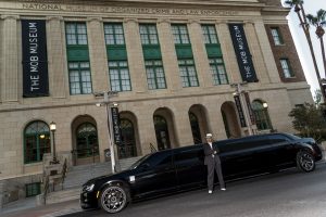 Photographers Of Las Vegas - Commercial Photography - The mob museum black limo mobster man gray suit white fedora shoes crossed arms