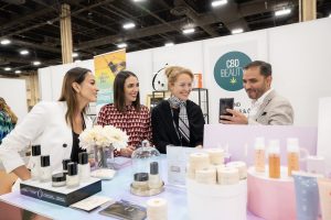 Photographers Of Las Vegas - Commercial Photography - CBD Beauty Cosmetics women smiling products man with phone