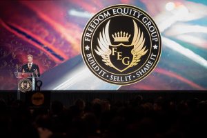 Photographers Of Las Vegas - Event Photography - Man blue suit blue yellow tie freedom equity group build it sell it share it speech