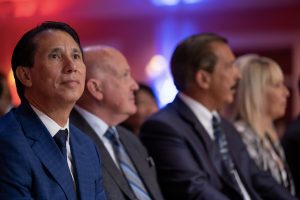 Photographers Of Las Vegas - Event Photography - Man blue suit blue tie crowd woman men