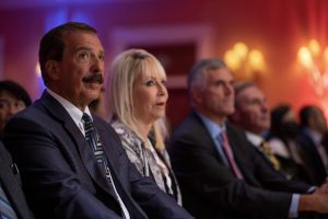 Photographers Of Las Vegas - Event Photography - Man blue suit blue green tie crowd woman men
