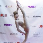 Photographers Of Las Vegas - Event Photography - Woman model gold outfit leg splits entertainment performance