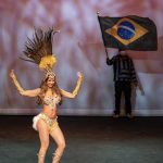 Photographers Of Las Vegas - Event Photography - Performer dancing feathers brazil flag yellow gold