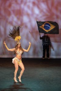 Photographers Of Las Vegas - Event Photography - Performer dancing feathers brazil flag yellow gold