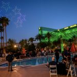 Photographers Of Las Vegas - Event Photography - stars lights sky drone show MGM Grand green pool party orange umbrellas