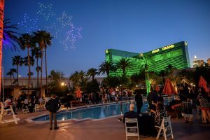 Photographers Of Las Vegas - Event Photography - stars lights sky drone show MGM Grand green pool party orange umbrellas