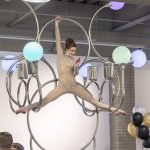 Photographers Of Las Vegas - Event Photography - Woman preforming gold outfit hanging chandelier splits black white gold balloons