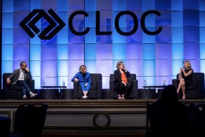 Photographers Of Las Vegas - Event Photography - Convention presentation CLOC blue backdrop black letters man women talking on stage