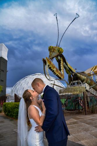 Photographers of Las Vegas - Vegas Strip Tour Photography - couple kiss in front of mantis at container park