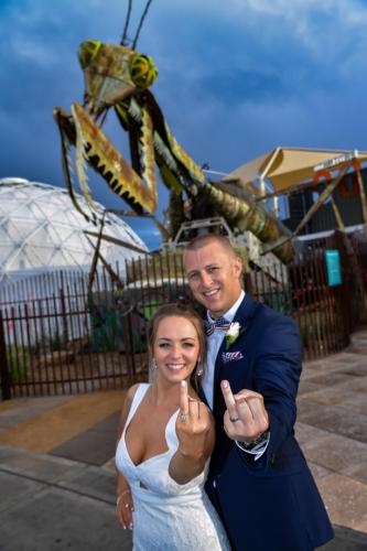 Photographers of Las Vegas - Vegas Strip Tour Photography - couple showing rings in front of mantis at container park
