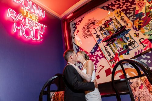 Photographers of Las Vegas - wedding photography - vegas wedding portraits with down the rabbit hole sign and playing cards
