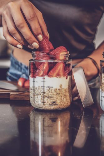 Photographers of Las Vegas - Product Photography - model putting strawberries in jars